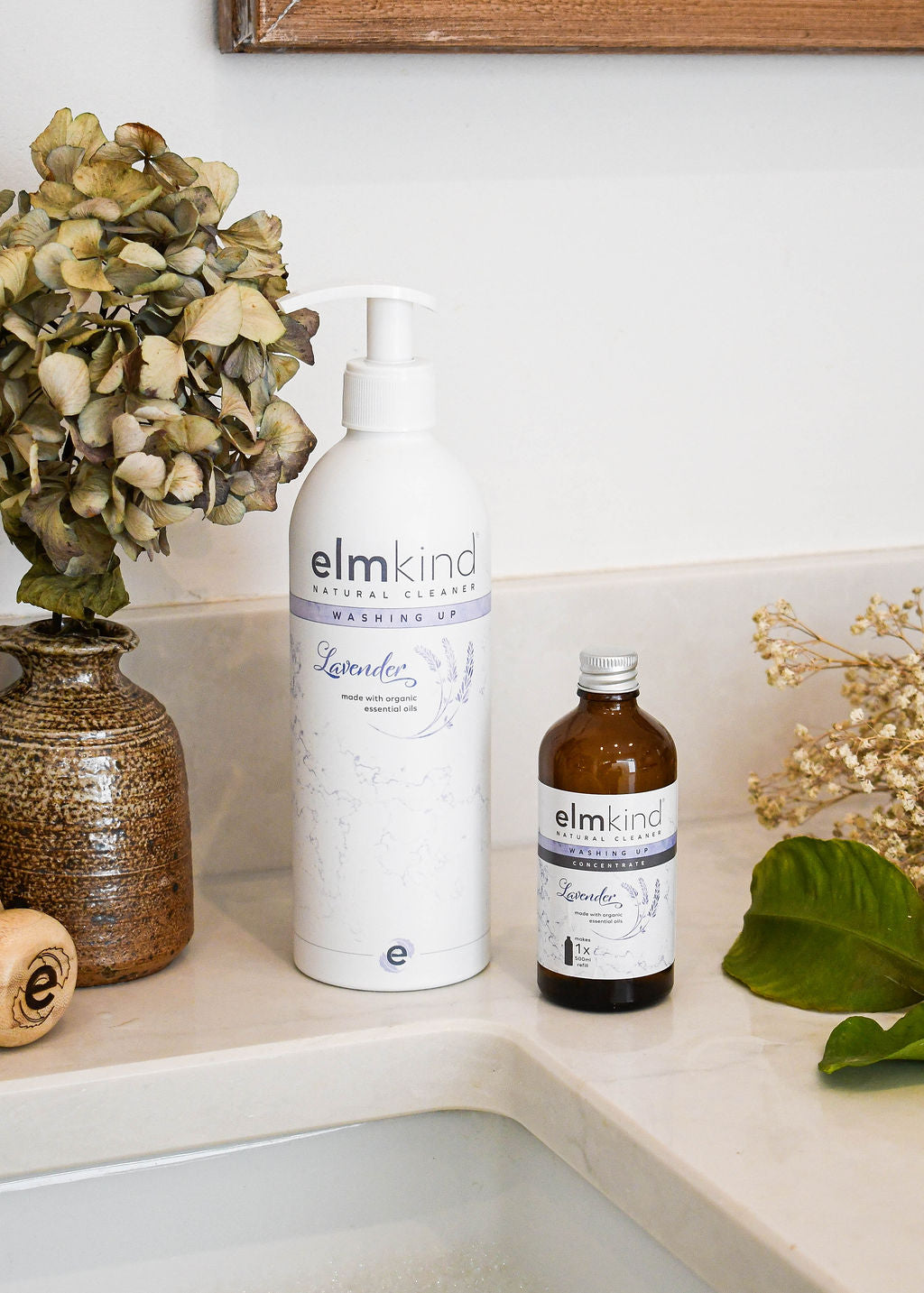 elmkind Lavender washing up liquid with plastic pump on kitchen side with dried flowers and a plastic free washing up liquid refill