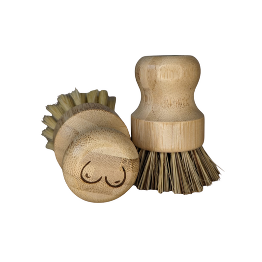 a pair of elmkind scrubbing brushes with breasts designed onto the handle to support breast cancer awareness, on a white background