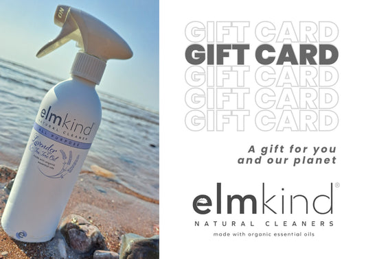 an elmkind all purpose aluminium bottle on a beach with writing to the side advertising a gift card.